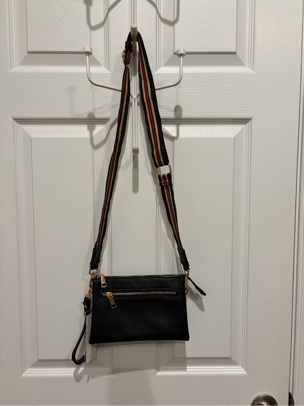 Sleek Black Crossbody with Striped Adjustable Strap